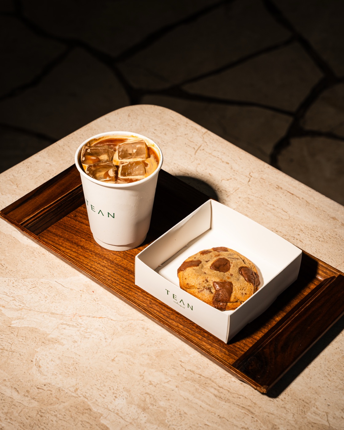 Iced coffee and a chocolate chunk cookie on a TEAN serving tray
